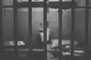 Black-and-white close-up of prison cell bars