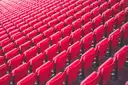 Rows of empty red stadium seats