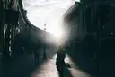 The curve of Regent Street in low sun, with walkers in silhouette