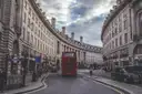 The curve of Regent Street, with a red double-decker bus and black cabs on the road
