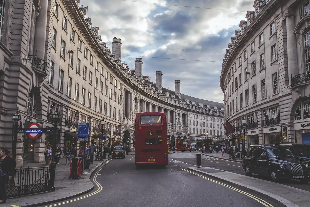 The curve of Regent Street, with a red double-decker bus and black cabs on the road