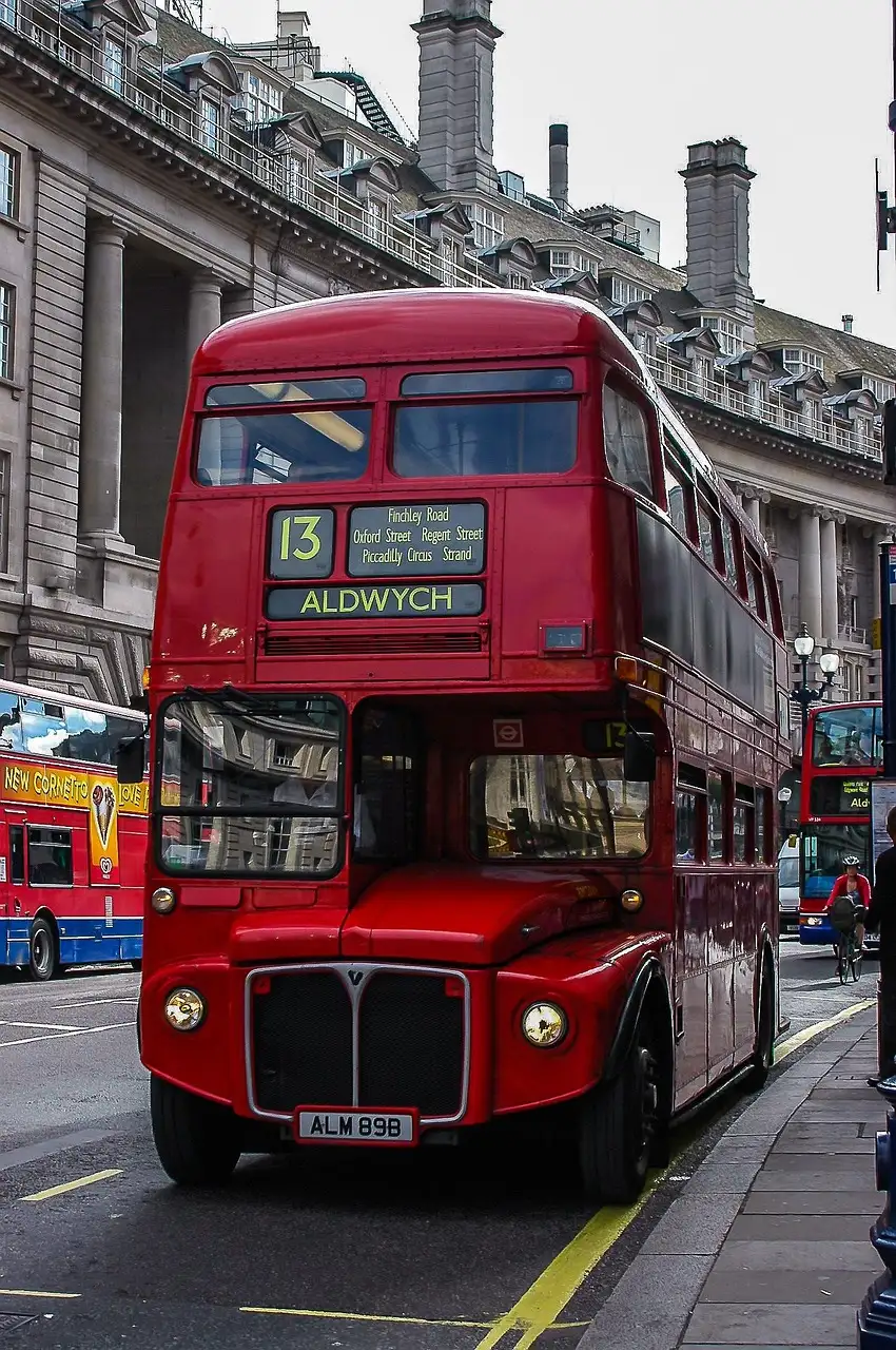 A vintage red Routemaster double-decker bus on a London street