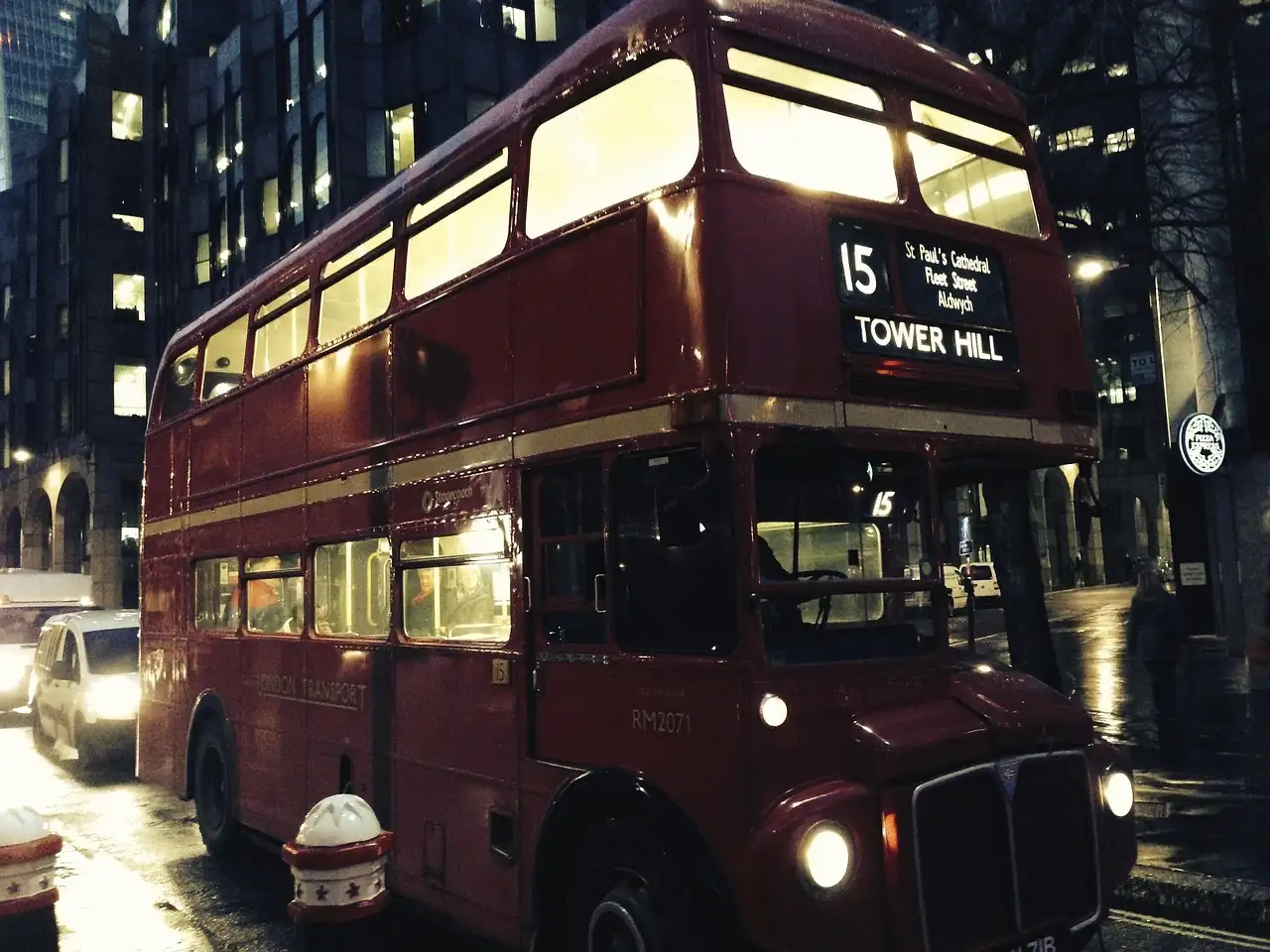 A vintage red Routemaster bus on route 15 to Tower Hill at night
