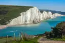 The white chalk cliffs of the Seven Sisters above a turquoise sea