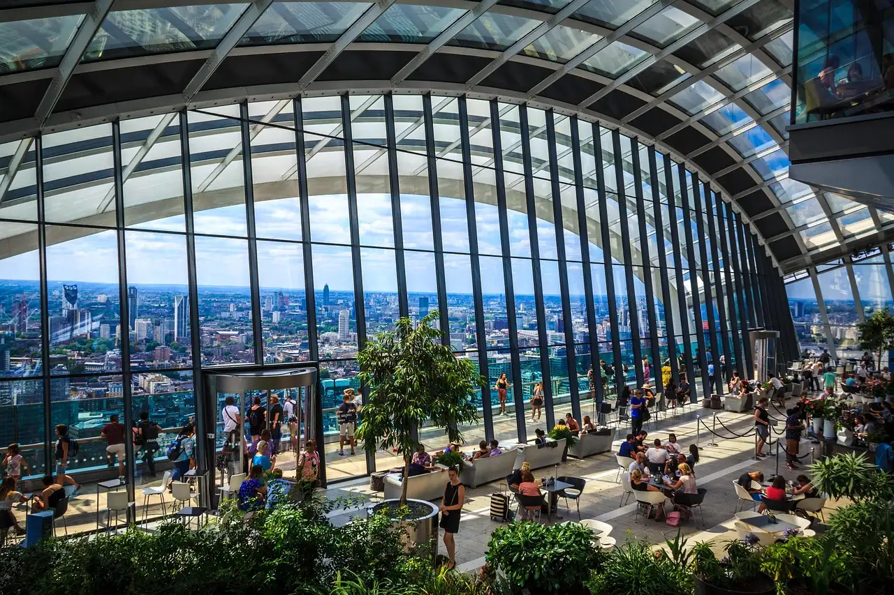 Inside the Sky Garden, plants under the curved glass roof with London below