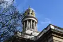 The white stone tower of St Marylebone Parish Church against a blue sky