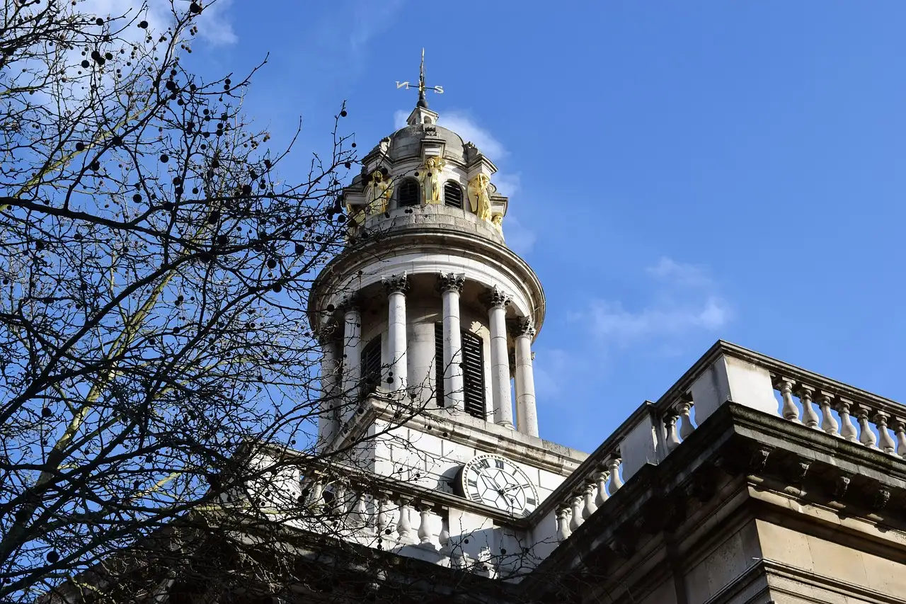 The white stone tower of St Marylebone Parish Church against a blue sky