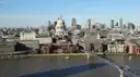City of London skyline with St Paul's dome and the Millennium Bridge