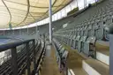 A walkway between rows of seats in a stadium stand