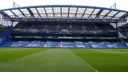 The blue stands of Stamford Bridge seen across the empty pitch