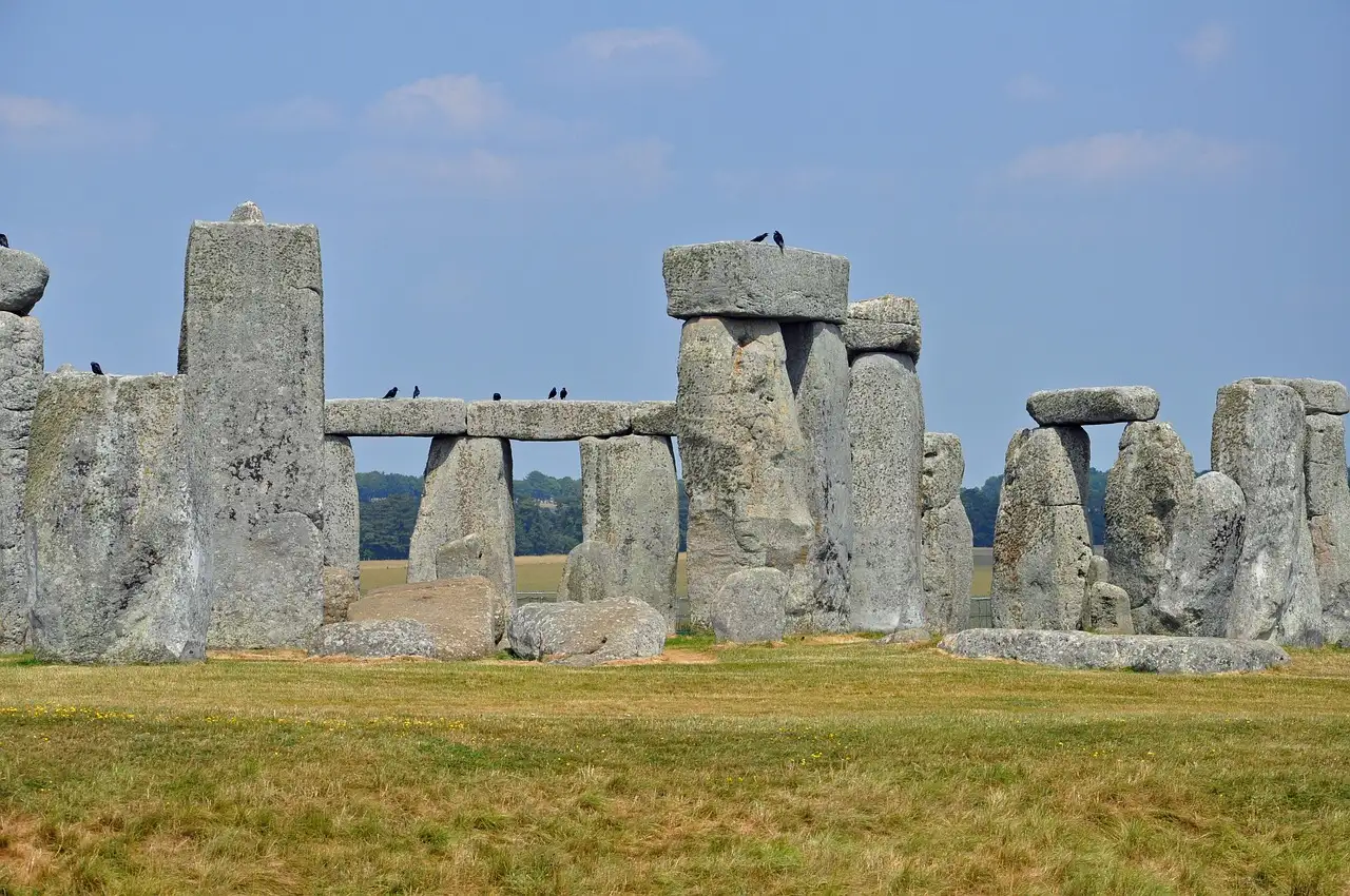 The sarsen stones of Stonehenge under a pale blue sky