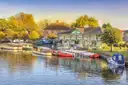 Boats moored on the River Avon at Stratford-upon-Avon in warm evening light
