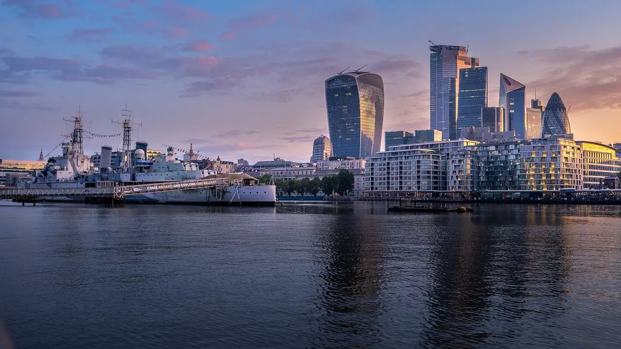 The Thames at dusk with HMS Belfast and the City of London towers behind