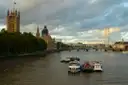 River boats on the Thames at Westminster with the Houses of Parliament and the London Eye behind