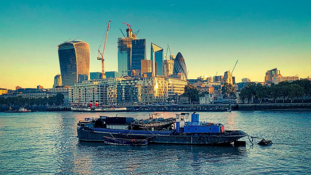 A boat on the Thames in front of the City of London skyline