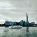 A passenger boat on the Thames with the Shard on the skyline