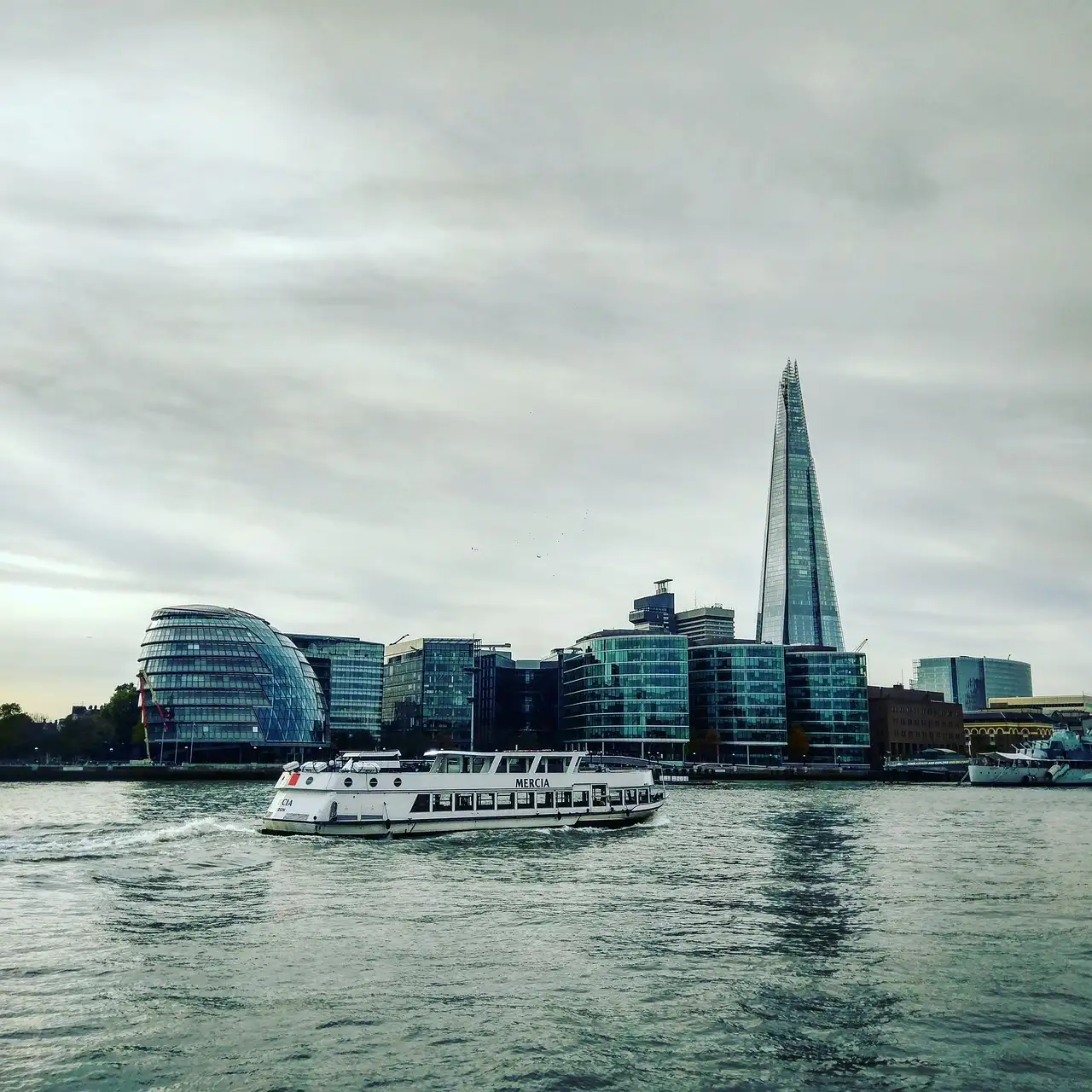 A passenger boat on the Thames with the Shard on the skyline