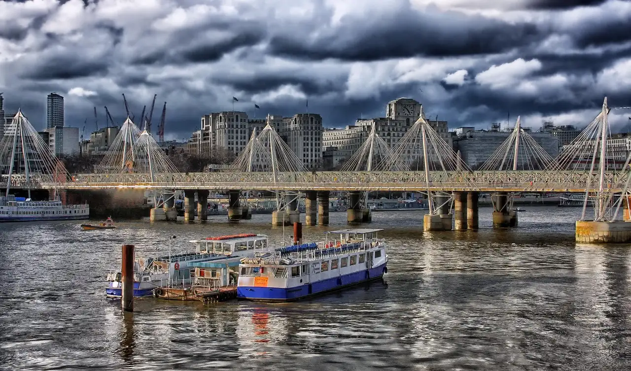 River boats moored on the Thames beside Hungerford Bridge