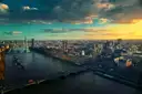 Aerial view of the River Thames and Westminster at sunset, with London stretching to the horizon