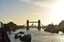Tower Bridge in golden light with boats on the river in front