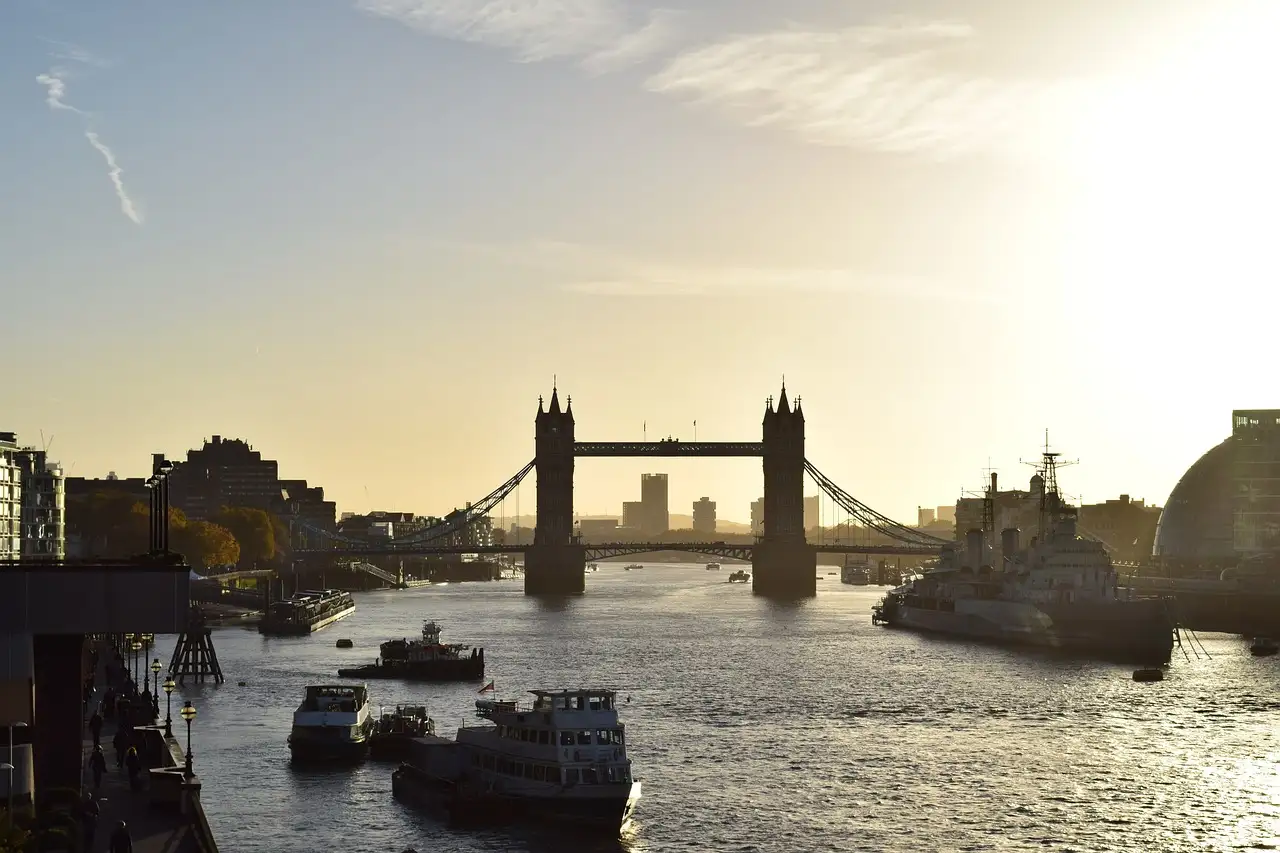 Tower Bridge in golden light with boats on the river in front