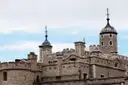 Domed turrets of the White Tower rising above the Tower of London walls
