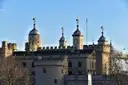 Turrets of the Tower of London against a clear blue sky