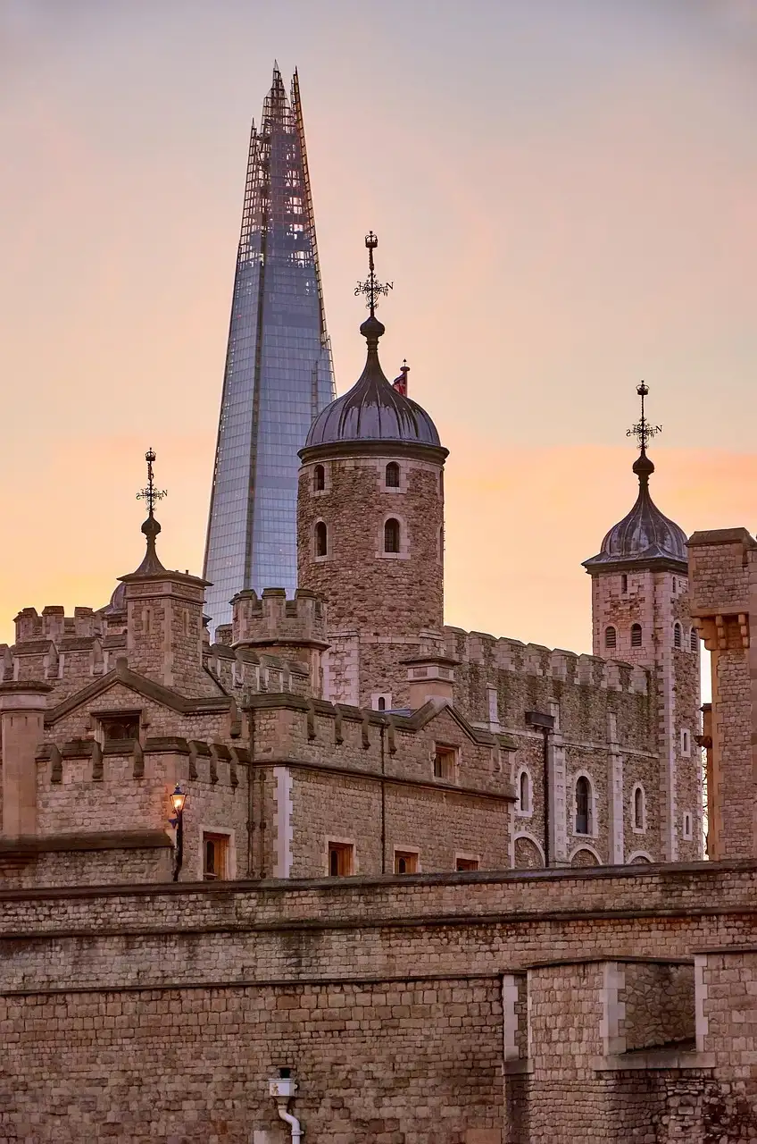 The turrets of the Tower of London at sunset, with the Shard behind