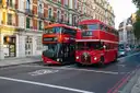 Two red double-decker buses on a London street