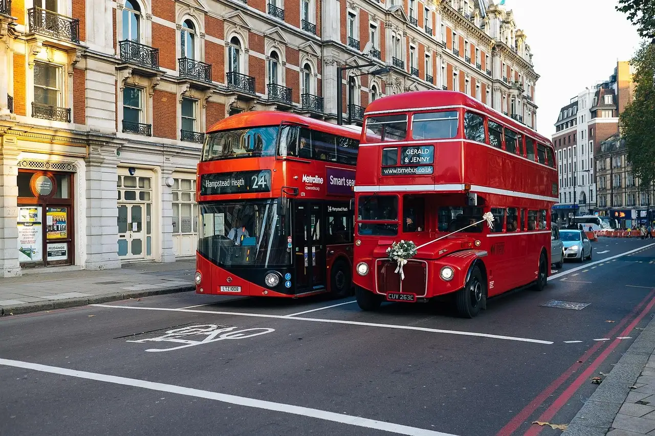 Two red double-decker buses on a London street