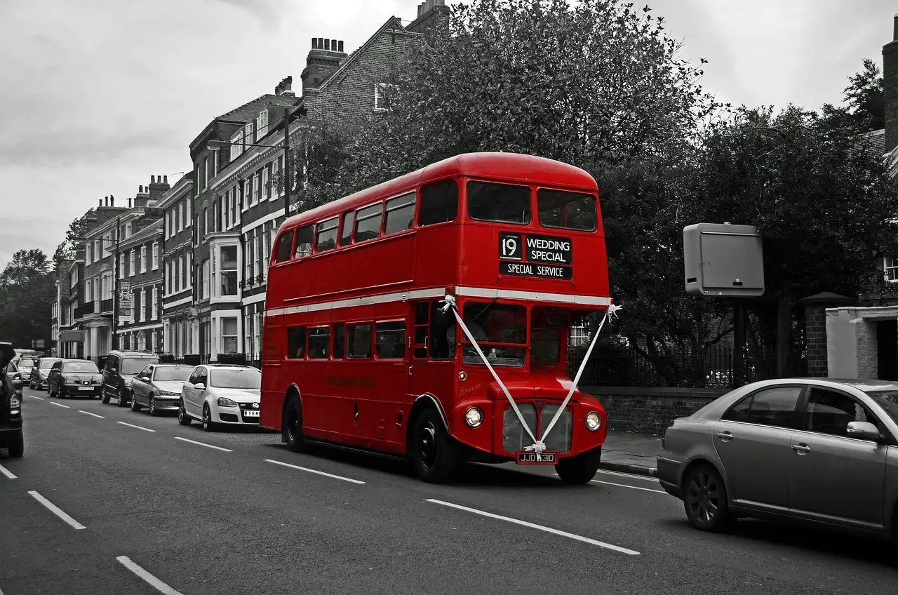 A vintage red Routemaster bus on a London street