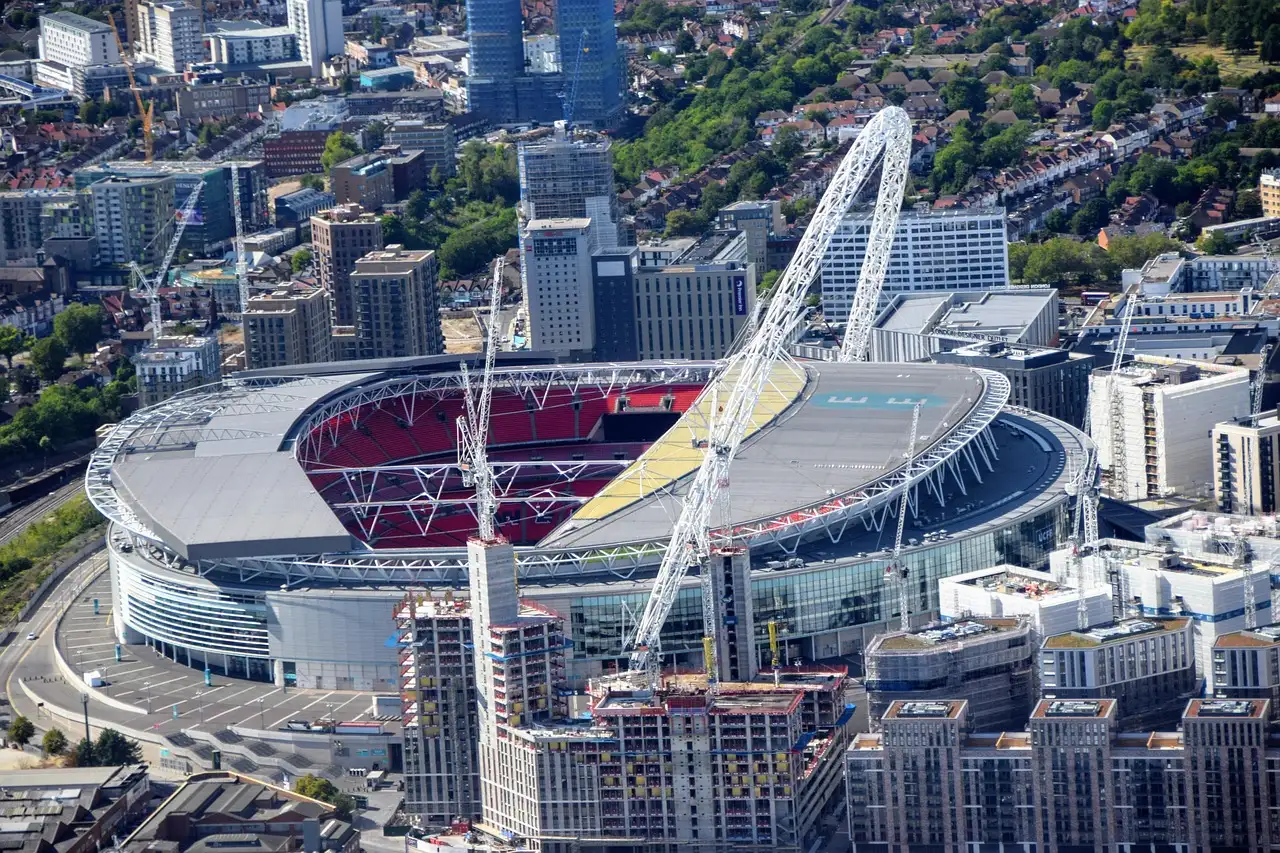 Wembley Stadium from the air, with its white arch over the roof