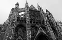 The Gothic north front of Westminster Abbey seen from below in black and white