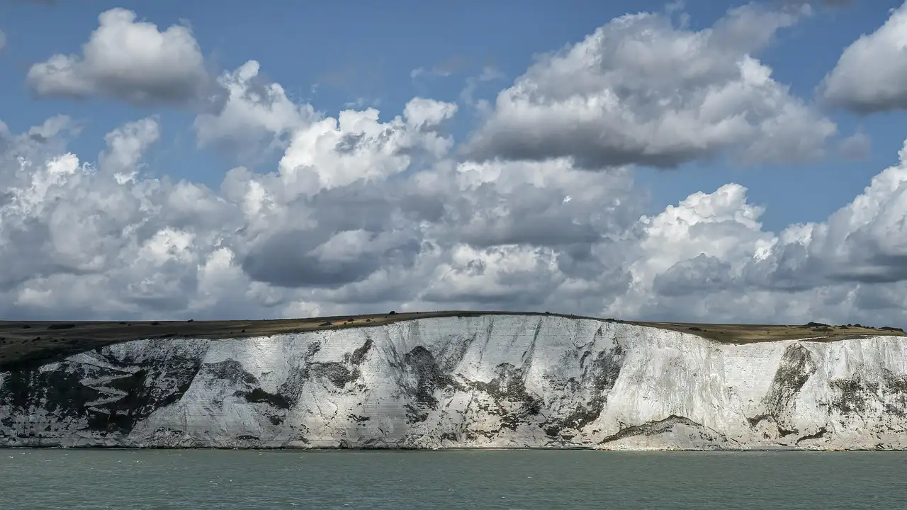 The White Cliffs of Dover seen from the sea under white clouds
