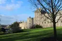 Windsor Castle seen across a sunny lawn