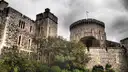 Windsor Castle's walls and the Round Tower rising above trees